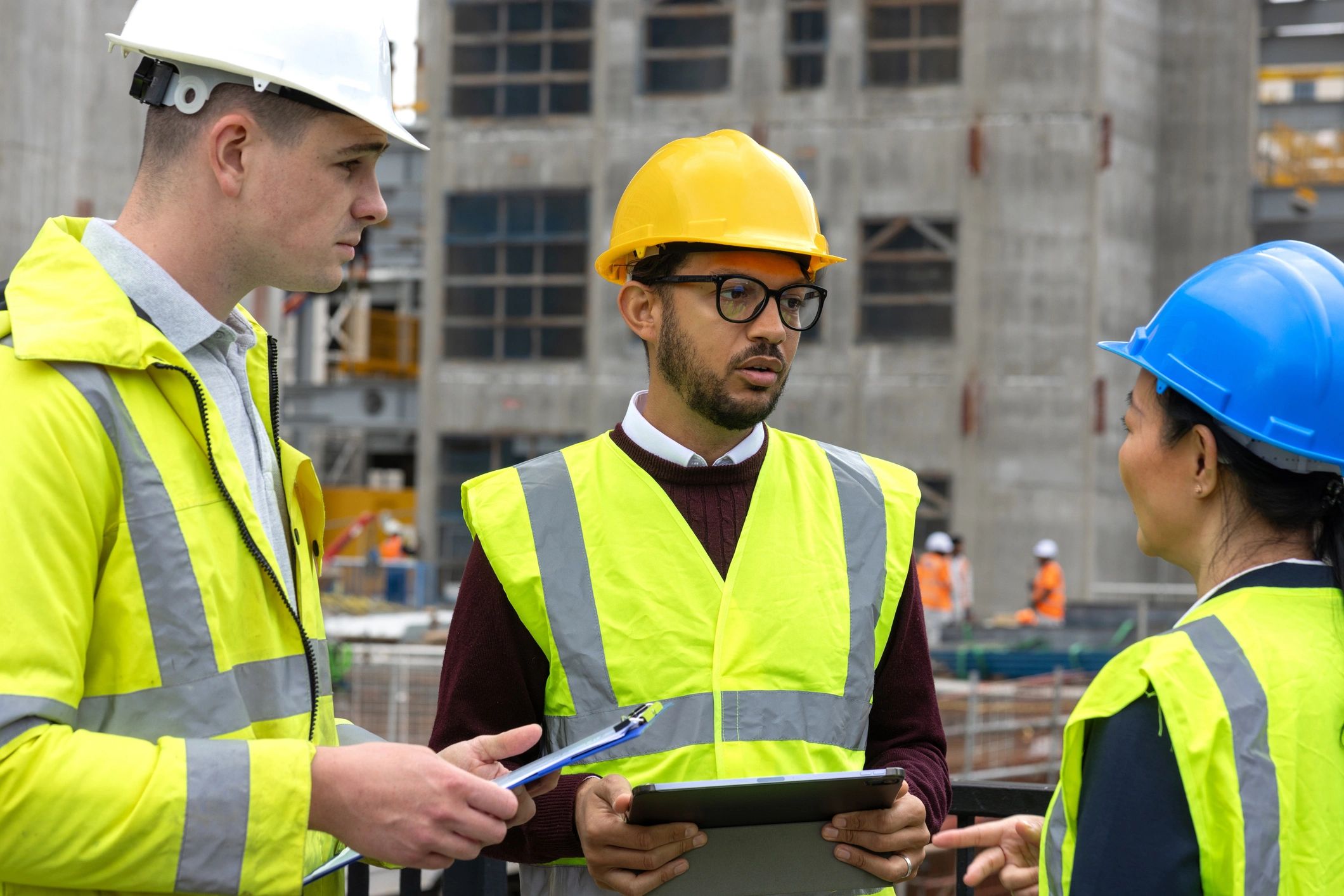 Construction professionals reviewing plans at a project site
